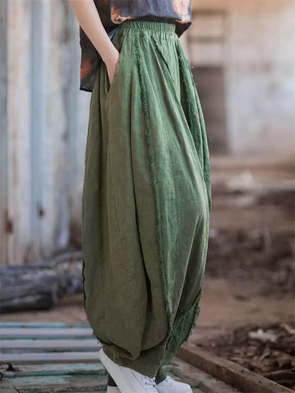 Pantalones vintage de tiro alto y pernera ancha tipo farol: corte holgado de ramio lavado con bajo sin rematar y silueta fluida.