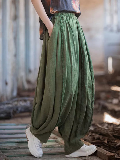 Pantalones vintage de tiro alto y pernera ancha tipo farol: corte holgado de ramio lavado con bajo sin rematar y silueta fluida.