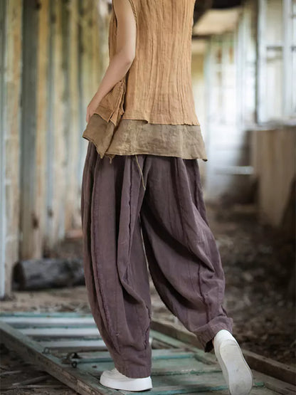 Pantalones vintage de tiro alto y pernera ancha tipo farol: corte holgado de ramio lavado con bajo sin rematar y silueta fluida.