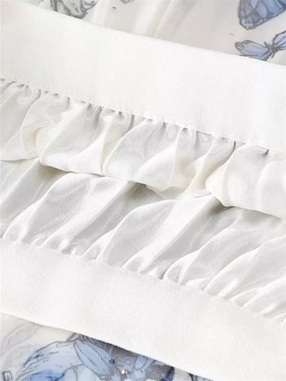 Aprikosenfarbener, geblümter, plissierter A-Linien-Tüll-Midirock in Midi-Länge mit Falten.