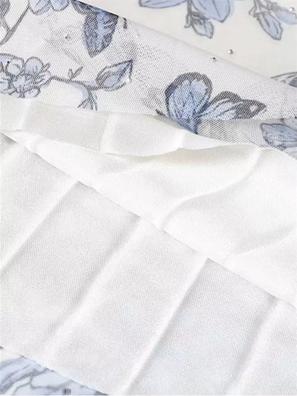 Aprikosenfarbener, geblümter, plissierter A-Linien-Tüll-Midirock in Midi-Länge mit Falten.