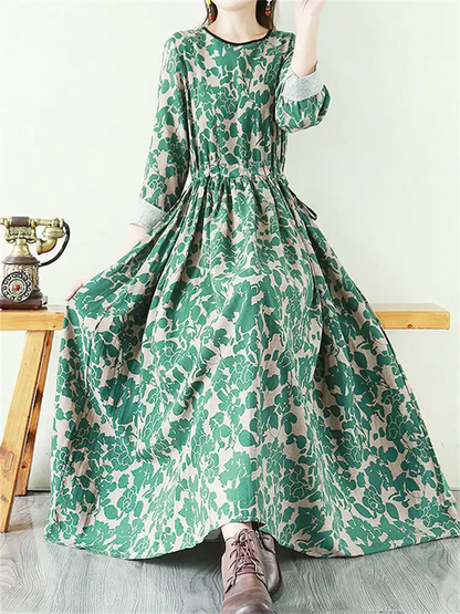 Vestido largo de lino con estampado floral fluido, cintura anudada y manga larga