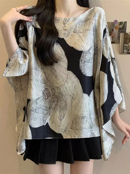 Elegante Bluse mit Fledermausärmeln und kontrastfarbenem, großem Blumenmuster